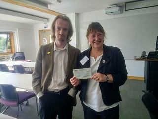 Photo: Chair of the Society of the Study of Labour History, Joan Allen, handing over the cheque associated with the prize.