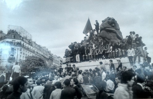Photographer Elie Kagan atop the Lion statue at Place Denfert-Rochereau