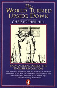 Book front cover. Purple-blue background. Author and title text. Image of two men in seventeenth century dress, one apparently about to be placed in the stocks.